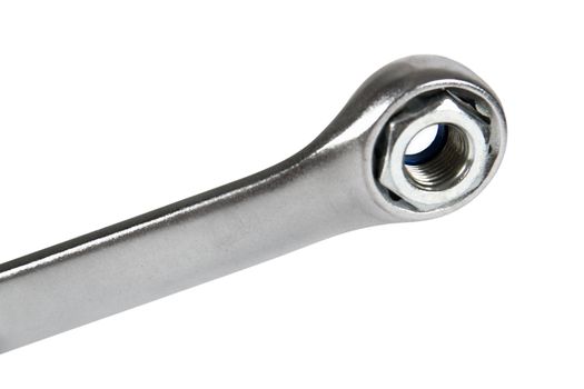 The image of a wrench with a nut, isolated, on a white background