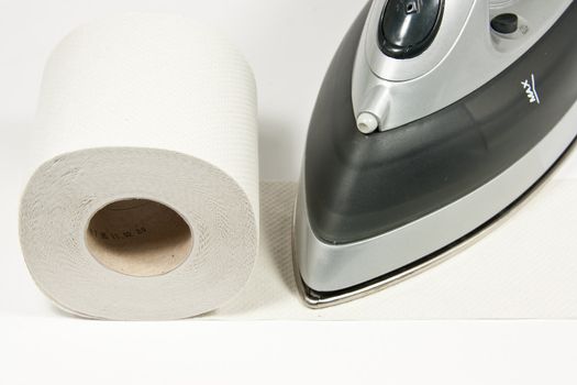 Picture of a iron thats ironing toilet paper