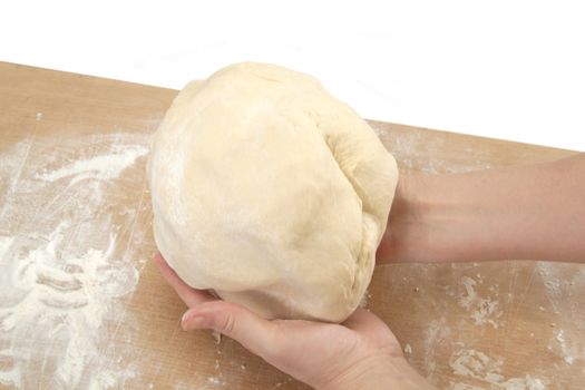 Beautiful women's hands knead the dough for baking
