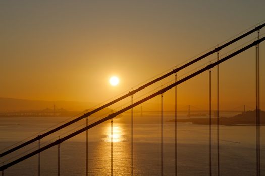 Golden Sunrise over Golden Gate Bridge and Oakland Bay Bridge