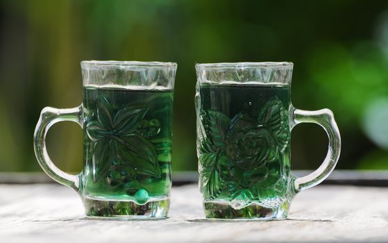 glass with green water