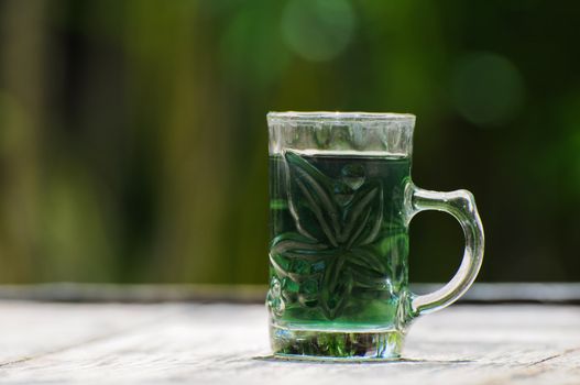 glass with green water