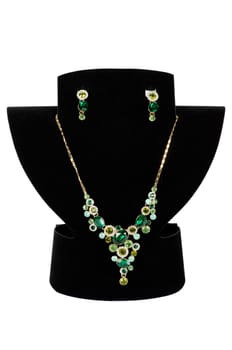 a necklace with pendants and earrings on a white background