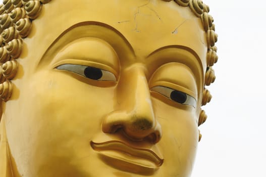 close up of golden buddha face
