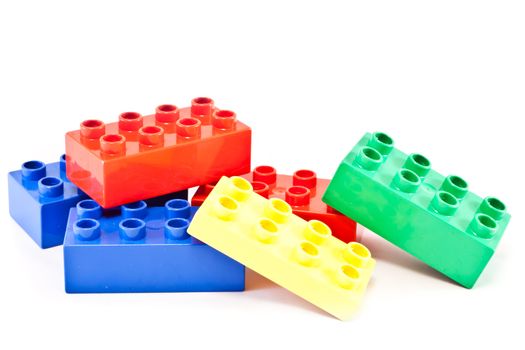 Plastic building blocks on white background. Bright colors.
