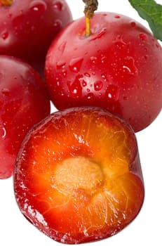 close-up wet ripe plums, isolated on white