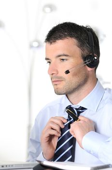 Young businessman with headset in office