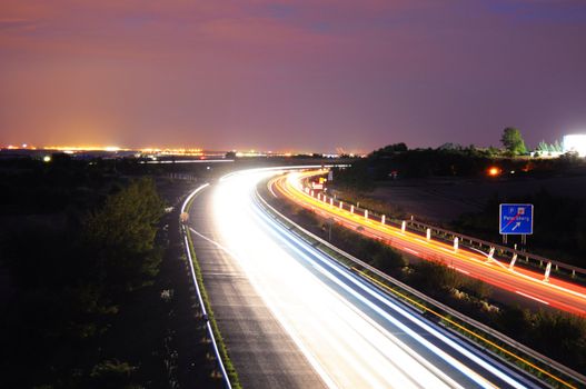 night time traffic on highway with lights showing transportation concept