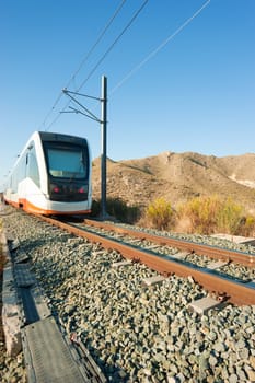 A modern electric train approaching the camera viewpoint