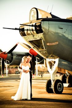 sexy young adult wedding couple standing with old war Albatross aircraft