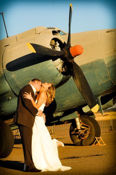 sexy young adult wedding couple standing with old war Albatross aircraft