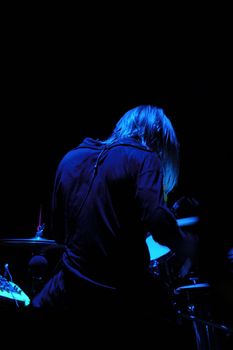 Drummer is playing. The light setting is blue. Note the stick is in motion blur.