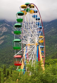 Ferris wheel against mountains background