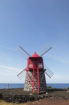 Red windmill in the coast of Pico island, Azores