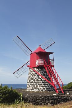 Red windmill in the coast of Pico island, Azores