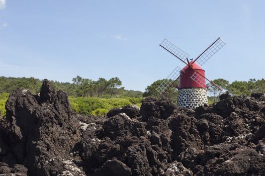 Red windmill in the coast of Pico island, Azores