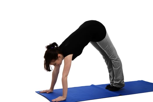 young woman exercising yoga on blue mat