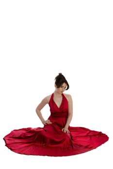 young beautiful woman in red evening dress sitting on floor