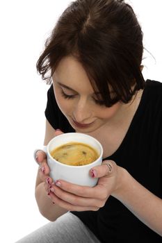 young pretty woman in black shirt scenting coffee in a mug
