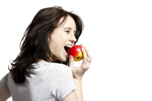 young happy woman eating red apple