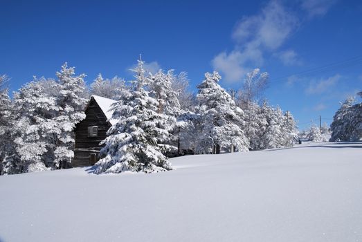 Mountain house in snow, winter sunny day