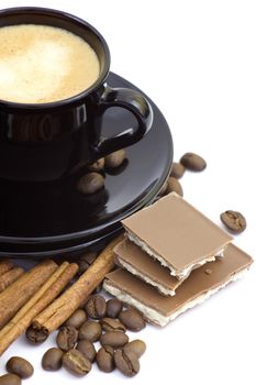 cup of italian espresso with cinnamon, coffee beans and chocolate