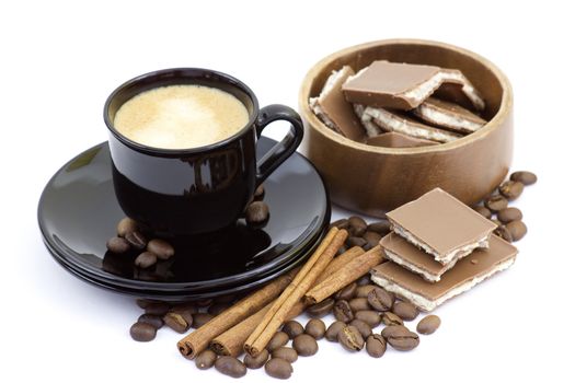 cup of italian espresso with cinnamon, coffee beans and chocolate