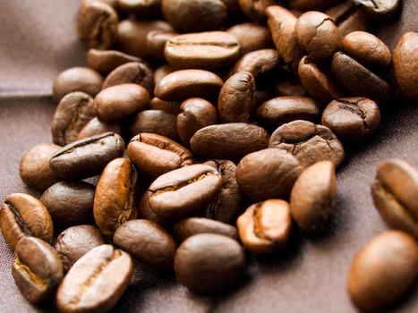 Roasted coffee beans on brown textile