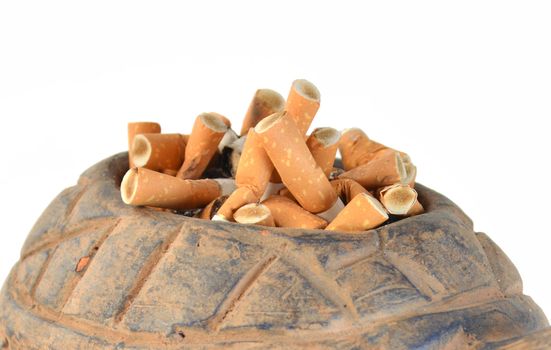 Cigarette butts in ashtray on white background