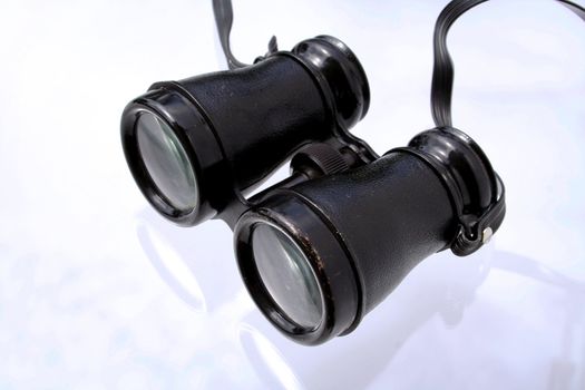 old black retro binoculars on white ground