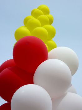 Red, yellow and white ballons in the sky