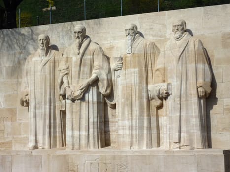 Sculptures of Guillaume Farel, Jean Calvin, Theodore de Beze and John Knox on the the wall of reformers in Geneva, Switzerland