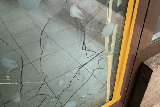 Broken glass of the entrance of a shop