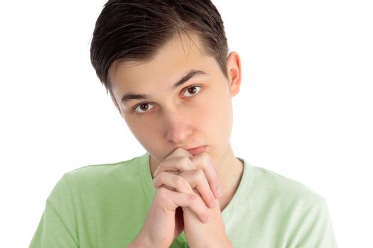 A boy with hands clenched in prayer.  White background.