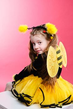 Pretty little girl dressed like a bee. Studio shot.