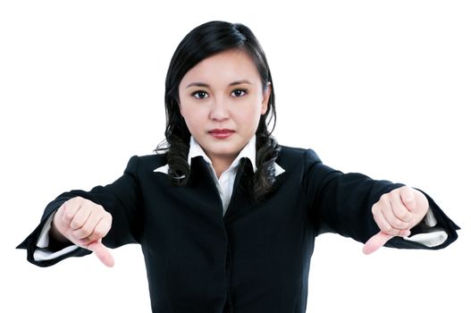 Portrait of an angry businesswoman giving thumbs down sign over white background.