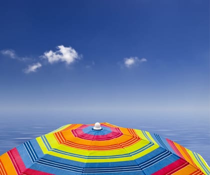 Beach parasol against blue sky and ocean