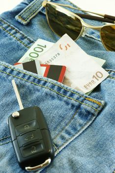 conceptual shot Ready to travel with jeans, money, credit cards and car key