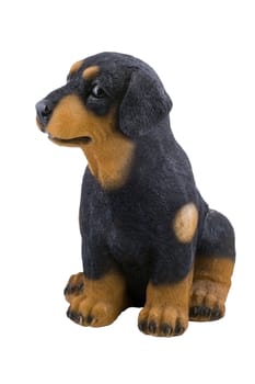 a small plastic toy doggie isolated on the white background