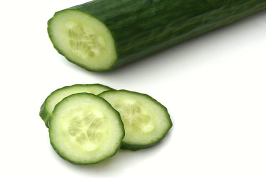 Part of a cucumber with some slices.