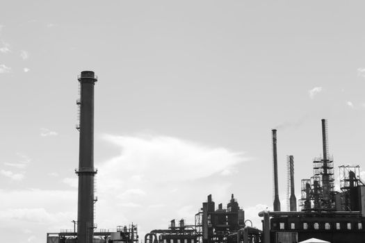 Factory with smoke stacks against blue sky