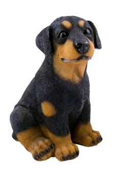 a small plastic toy doggie isolated on the white background