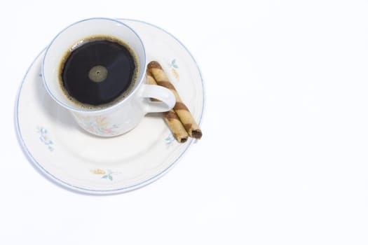 Cup of black coffee and wafer biscuit on white background