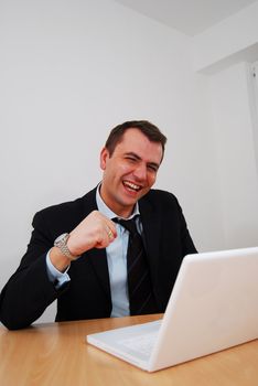 Happy businessman cheering over big win