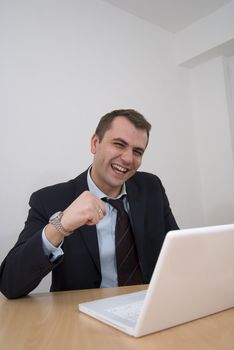 Happy businessman cheering over big win