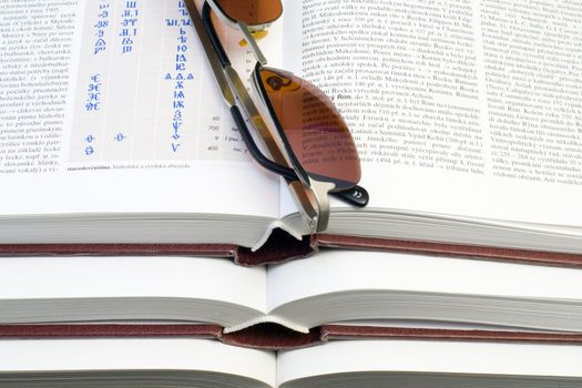 glasses lying on the pile of books - close up