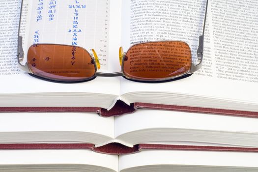 glasses lying on the pile of books - close up