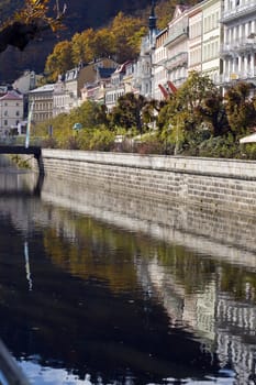 city boulevard in Bohemian spa mirrored in the river