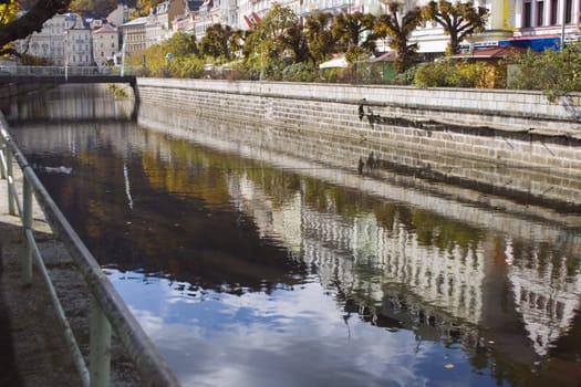 city boulevard in Bohemian spa mirrored in the river