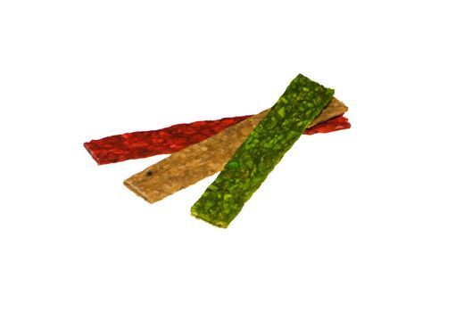 red, green and yellow dog treats isolated on the white background